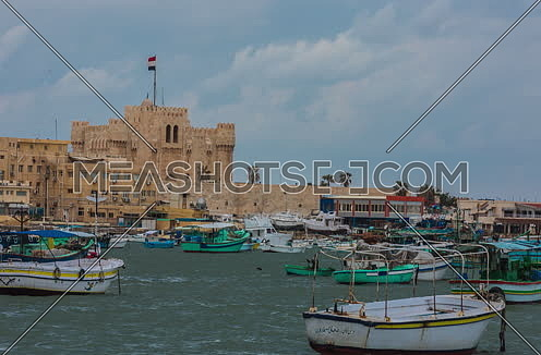 Track Left Long Shot outside Citadel of Qaitbay shows fishing boats at day