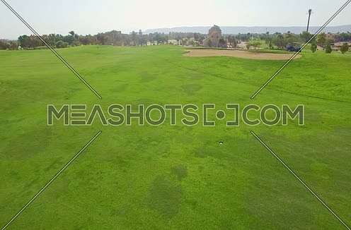 Drone shot flying above a golf course Al Gouna at Day 