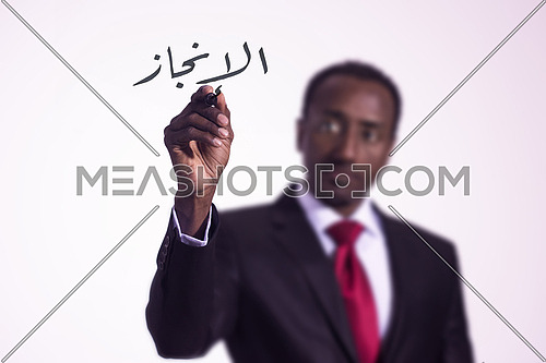 African man writing with a marker on virtual screen in arabic