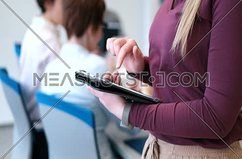 Close up shot for Pretty Businesswoman hands Using Tablet In Office Building during conference