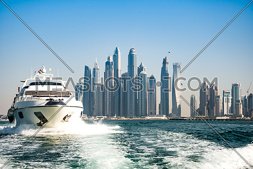 a luxury yacht infront of dubai marina waterfront