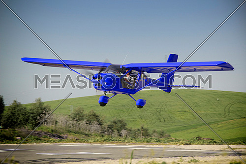 a blue plane manned by student and flight instructor of a class flight practice