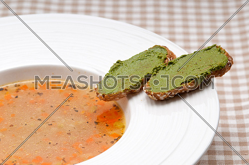 classic Italian minestrone " passato"soup with pesto crostini on side