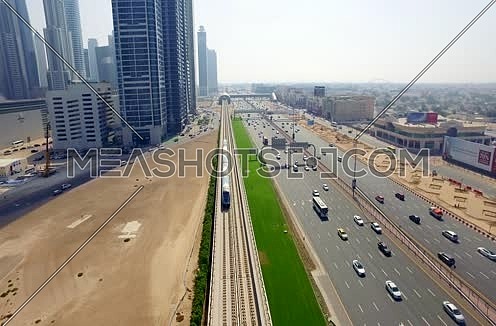 Arial shot for Al Shaikh Zayed Road Using Drone following the train in Dubai At Day
