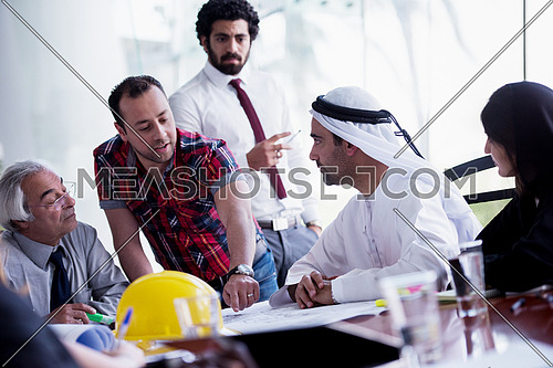 business people group on meeting, contractor and architect presenting plans and projects to middle eastern businessman investor