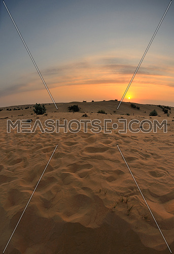 sunset with blue sky and clouds over sand dunes in sahara desert