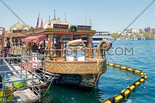 Istanbul, Turkey - April 25, 2017: Traditional fast food bobbing boat serving fish sandwiches at Eminonu with chefs preparing meals