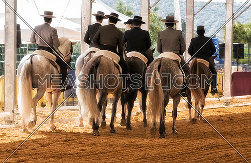 Group of horsemen riding on their backs after dressage exhibition denim in Andujar, Jaen province, Andalucia, Spain