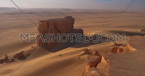 Aerial shot for Two 4x4 Cars moving through sand dunes in the desert at day