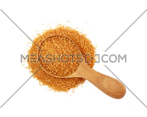 Wooden scoop spoon of brown cane sugar with pinch of sugar spilled around isolated on white background, top view