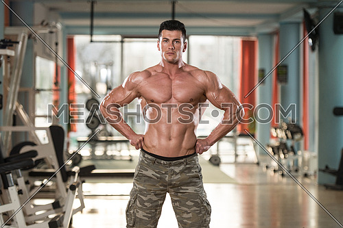 Portrait Of A Physically Fit Young Man In Modern Fitness Center