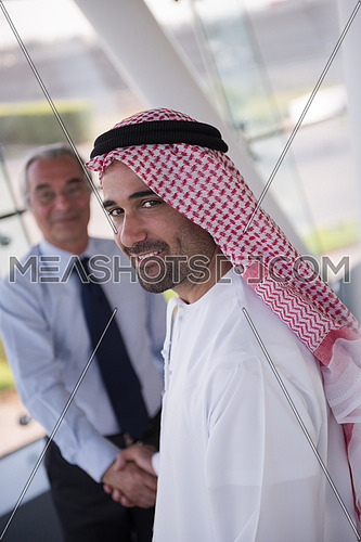 arabian businessmans make deal and handshake with company director at modern meeting room