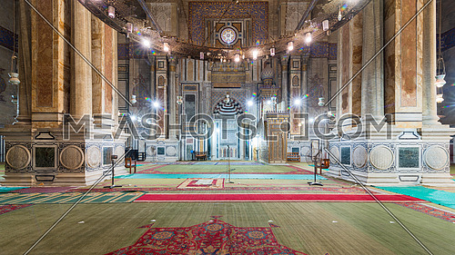 Interior of public historical Al Rifaii Mosque, aka Royal Mosque, with colorful decorated engraved Mihrab and wooden Minbar, Cairo, Egypt