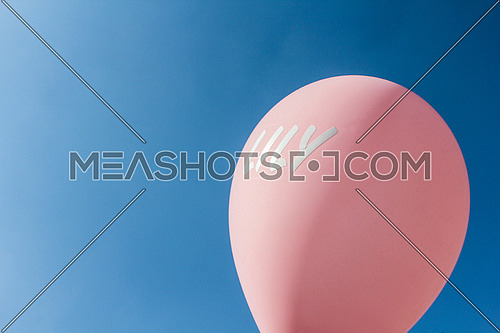 A pink balloon in the sky written on it lily