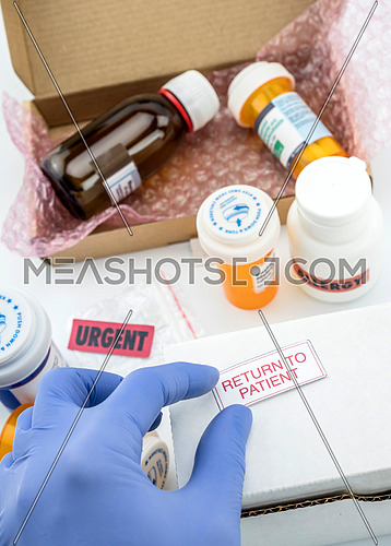 Nurse unpacking medication in boxes, pasting label return to the patient, conceptual image, composition vertical