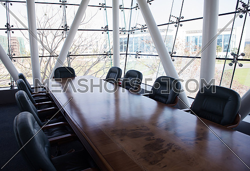 Interior of new modern corporate office meeting room with big glass windows