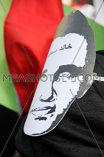 A mask of khaled said during a protest