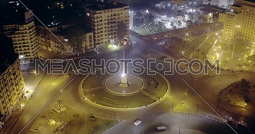 Drone shot fly towards Tahrir Square showing National Flag Pole in Cairo at night