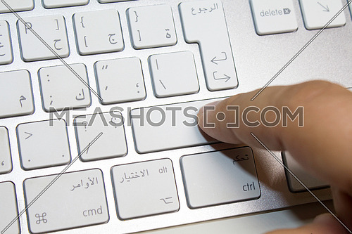 finger pressing on shift key on arabic keyboard