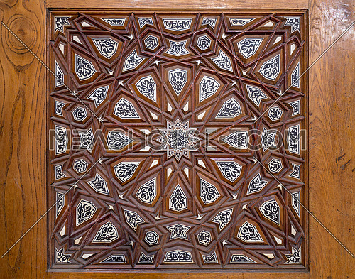 Closeup of arabesque ornaments of an old aged decorated wooden door, Old Cairo, Egypt