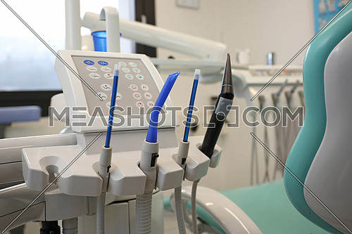 Closeup of metallic dentist tools and drills in dentistry clinic