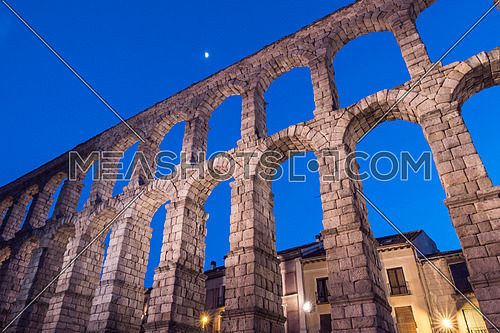 Partial view of the Roman aqueduct located in the city of Segovia at night , Unesco World Heritage Site, Spain