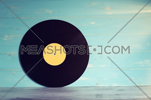 Vinyl record on wooden background,Old vintage vinyl record isolated