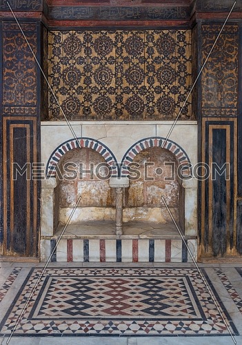 Wooden wall decorated with painted floral patterns, embedded arched niche and marble floor decorated with geometric patterns at ottoman era historic house of Moustafa Gaafar Al Seleehdar, Cairo, Egypt
