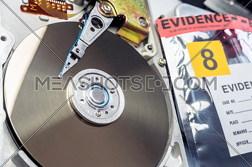 Hard disk opened in criminological laboratory, conceptual image