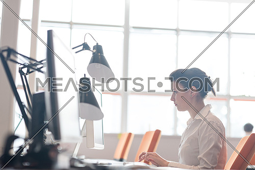 business woman working on desktop computer at modern startup office