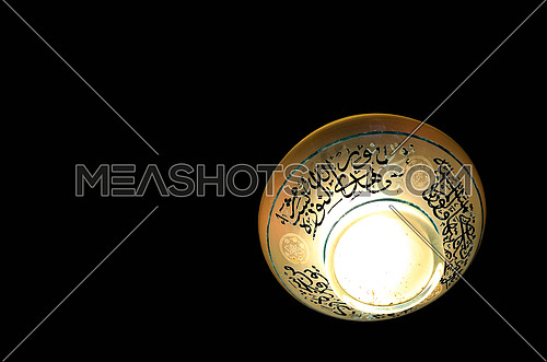 A ceiling lamp with islamic writings isolated on black