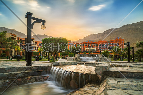 a small waterfall landscape in a mountain resort