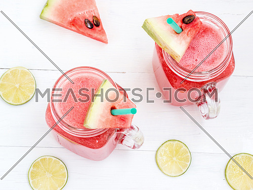 Watermelon smothie and slices on white wooden background. Top view