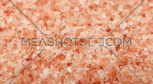 Close up background texture of large and medium crystals pink Himalayan salt, high angle view, selective focus