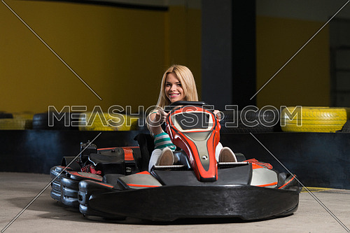 Young Woman Is Driving Go-Kart Car With Speed In A Playground Racing Track - Go Kart Is A Popular Leisure Motor Sports