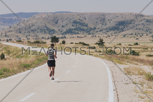 Young man and woman in protective masks running and doing exercises outdoors in the morning. Sport, Active life, Jogging during quarantine. Covid-19 new normal. High quality photo. Selective focus.