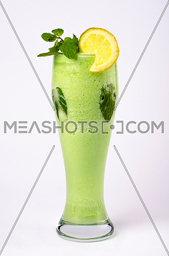 lemon with peppermint in a tall glass isolated on white