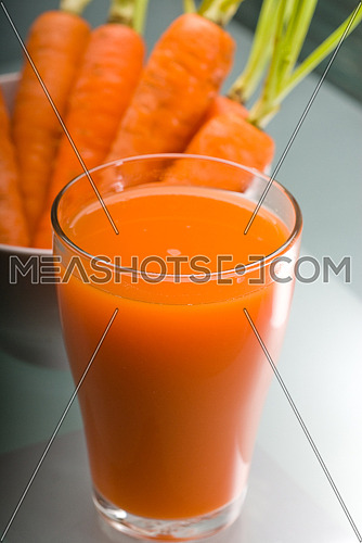 fresh and healty carrot juice unfiltered over a light table