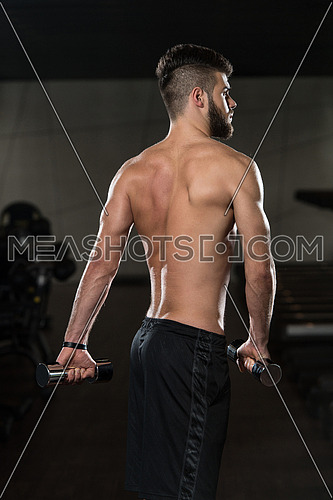 Portrait Of A Young Sporty Man In The Modern Gym With Exercise Equipment