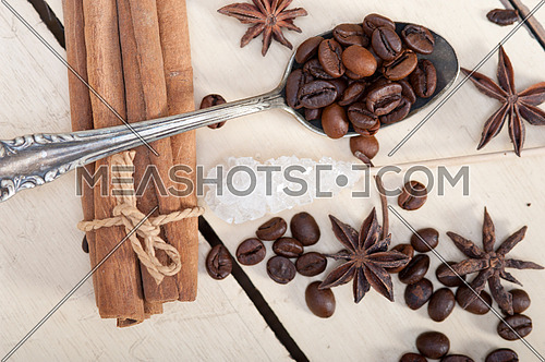  coffe sugar and spice on silver spoon over white wood rustic table 