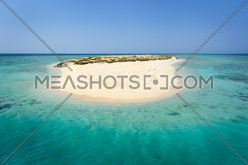 In the picture an atoll with fine white sand, turquoise sea and surrounded by green situated in the Red Sea in Egypt, situated between the area of Hamata and Berenice.