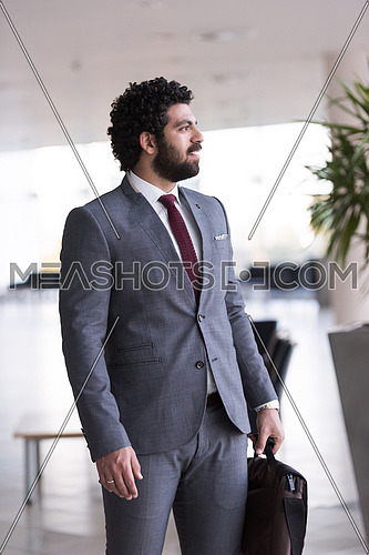 handsome middle eastern business man portrait with laptop bag  at airport terminal