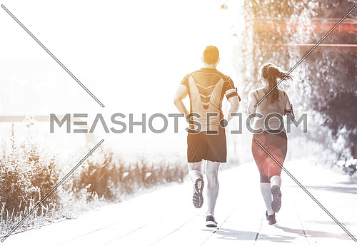 urban sports, healthy young couple jogging  in the city at sunny morning