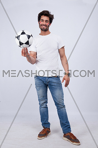 a  young man with a white t-shirt holding football on a white background
