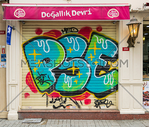 Istanbul, Turkey - April 18, 2017:  Closed shop exterior with metal rolling door covered with colorful graffiti near Istiklal Street