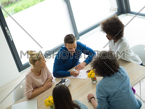 Multiethnic Group of business people discussing business plan  in the startup office