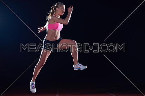 Athletic woman running on athletics race  track