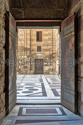 Opened door leading to the courtyard of Al-Sultan Al-Zahir Barquq mosque. Al-Moez Street, Old Cairo, Egypt