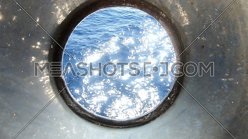 Close up for the sea from boat hatch at day