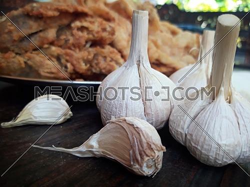 Garlic on the table against the background of dishes
